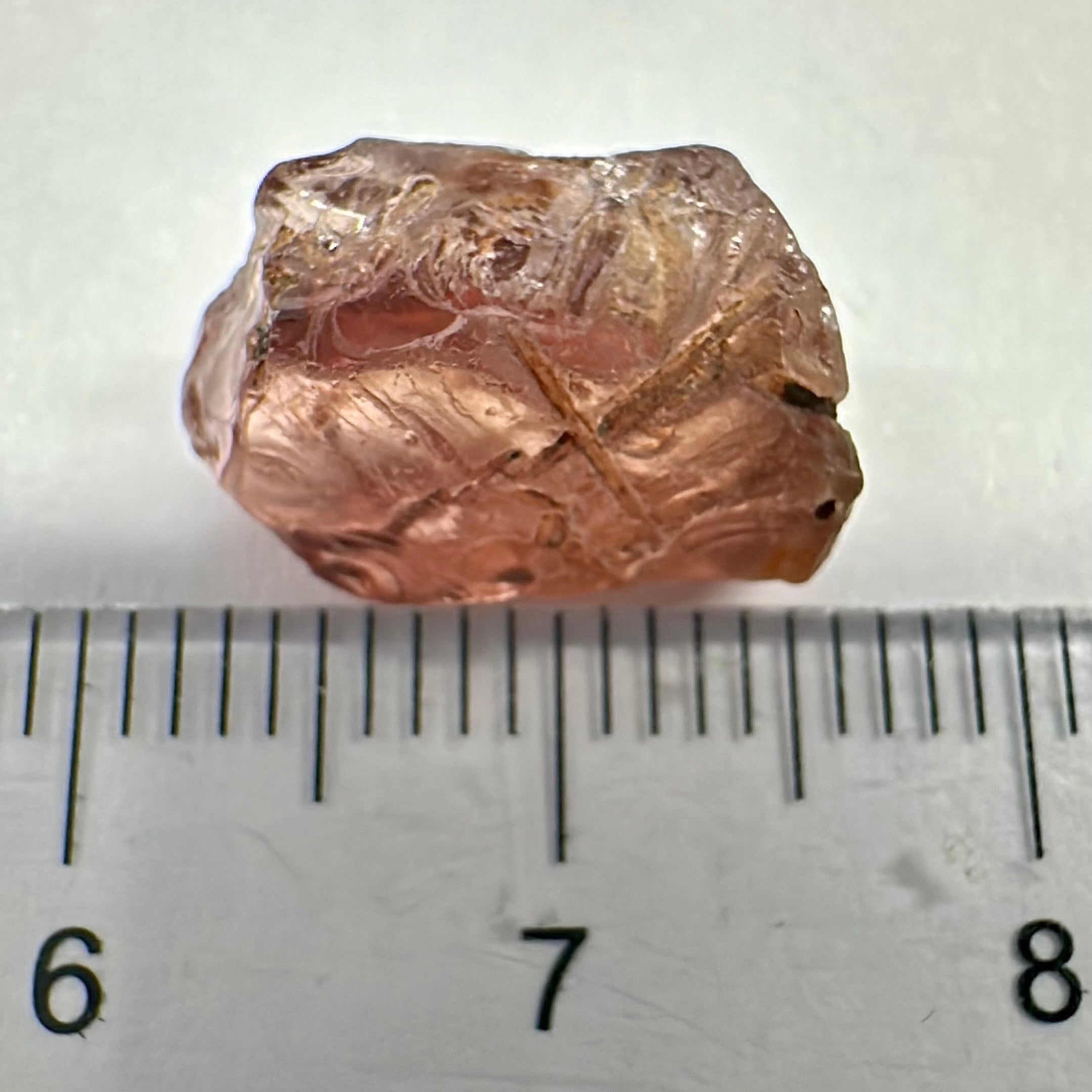 Peach Malaya Garnet, Very Interesting Hollow Pipe inclusions, see all the pictures, 7.38ct, inside vvs-if with slight hollow needle inclusion on the outside, Unheated Untreated, Umba Valley Tanzania