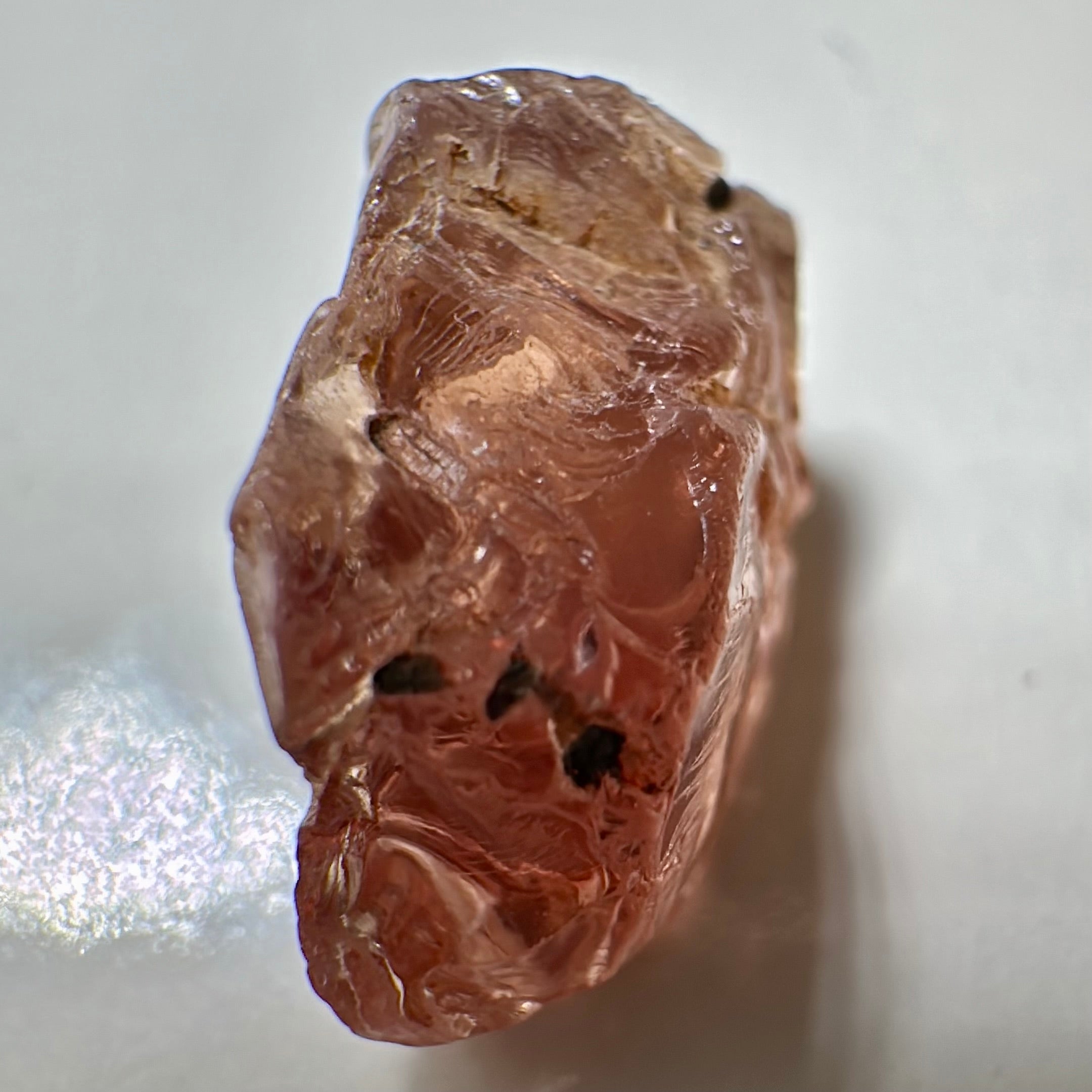 Peach Malaya Garnet, Very Interesting Hollow Pipe inclusions, see all the pictures, 7.38ct, inside vvs-if with slight hollow needle inclusion on the outside, Unheated Untreated, Umba Valley Tanzania