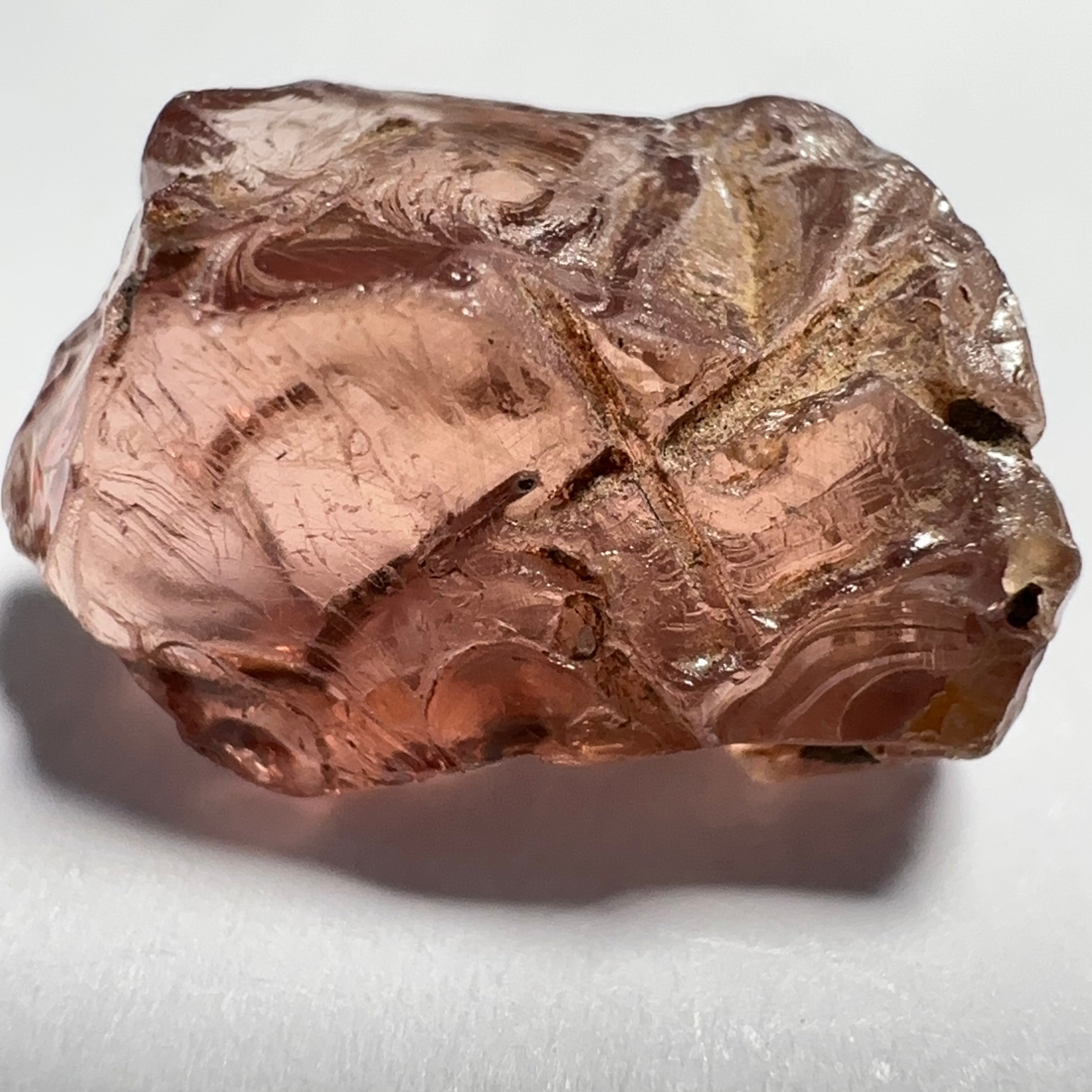 Peach Malaya Garnet, Very Interesting Hollow Pipe inclusions, see all the pictures, 7.38ct, inside vvs-if with slight hollow needle inclusion on the outside, Unheated Untreated, Umba Valley Tanzania