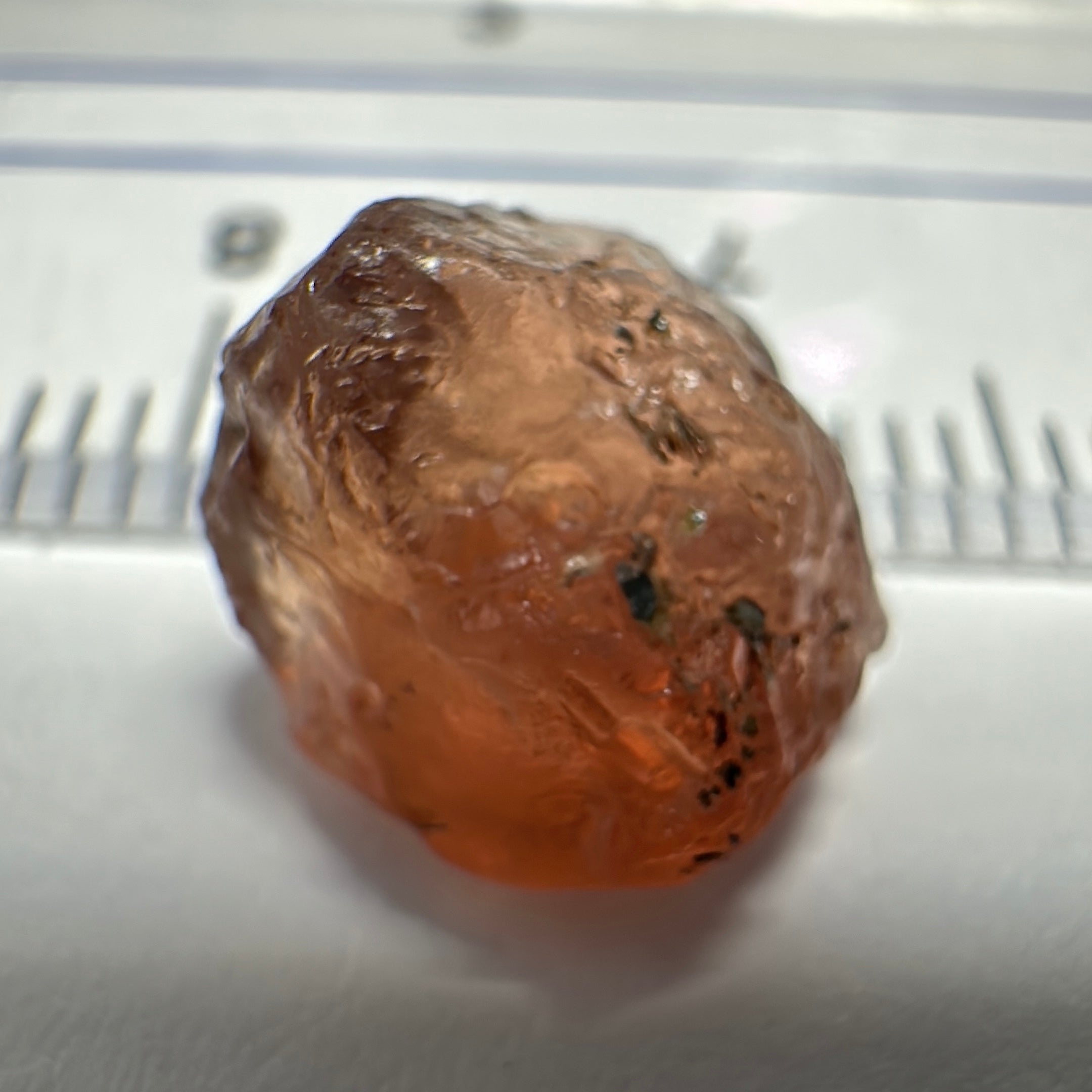 Peach Malaya Garnet, 6.02ct, slight crack 1mm inside from skin, slight gunk on skin on one end needs to be removed on disk, rest slightly silky, Unheated Untreated, Umba Valley Tanzania